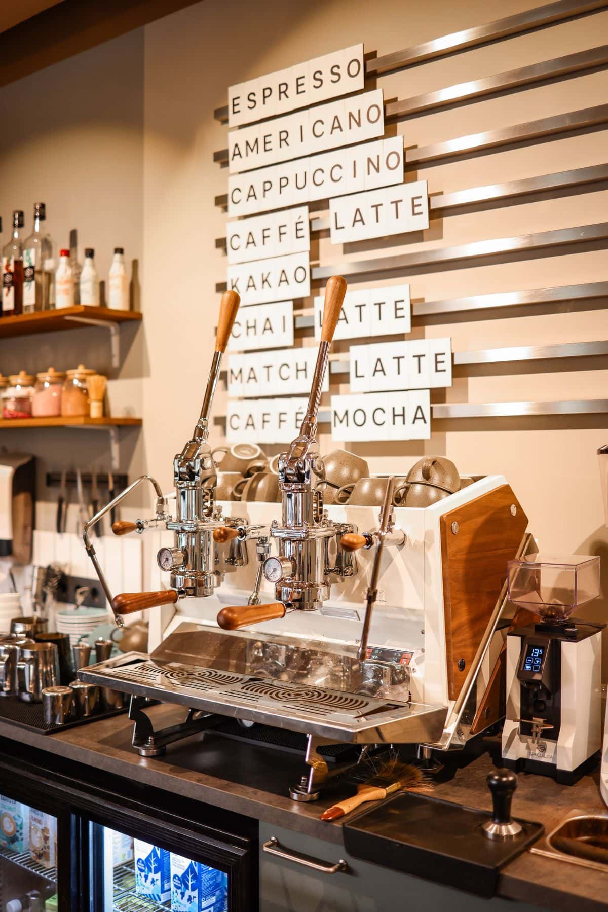 Espresso machines under a letterboard cafe menu