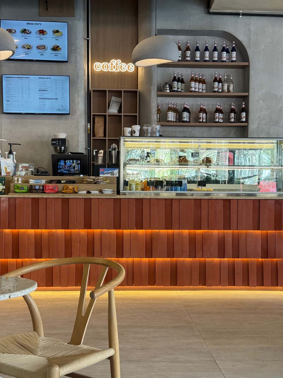 Coffee shop counter with a lit pastry case