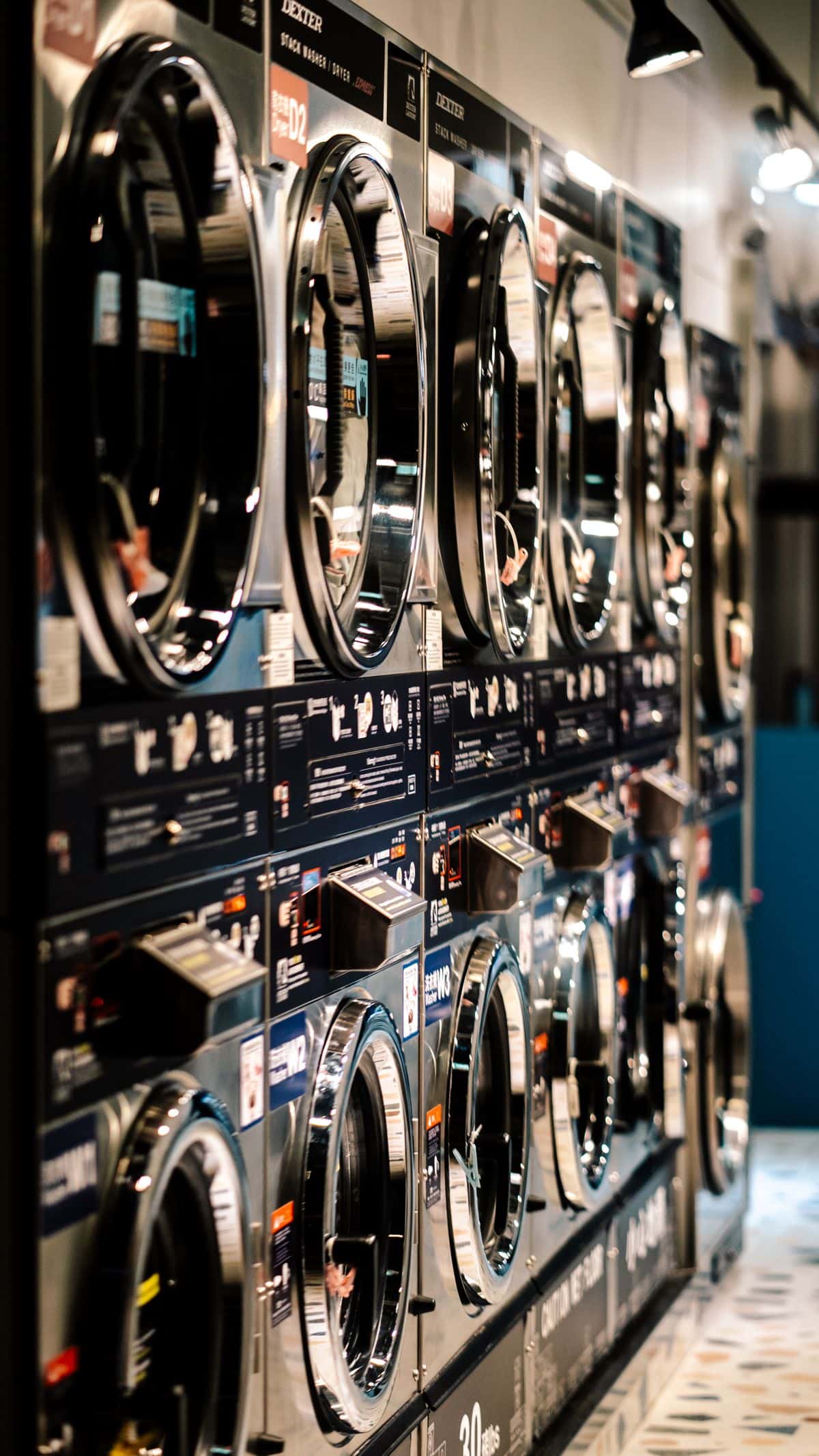 Wall of stacked laundromat washing machines